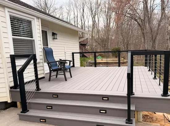 Composite deck with cable railing and lit stair risers