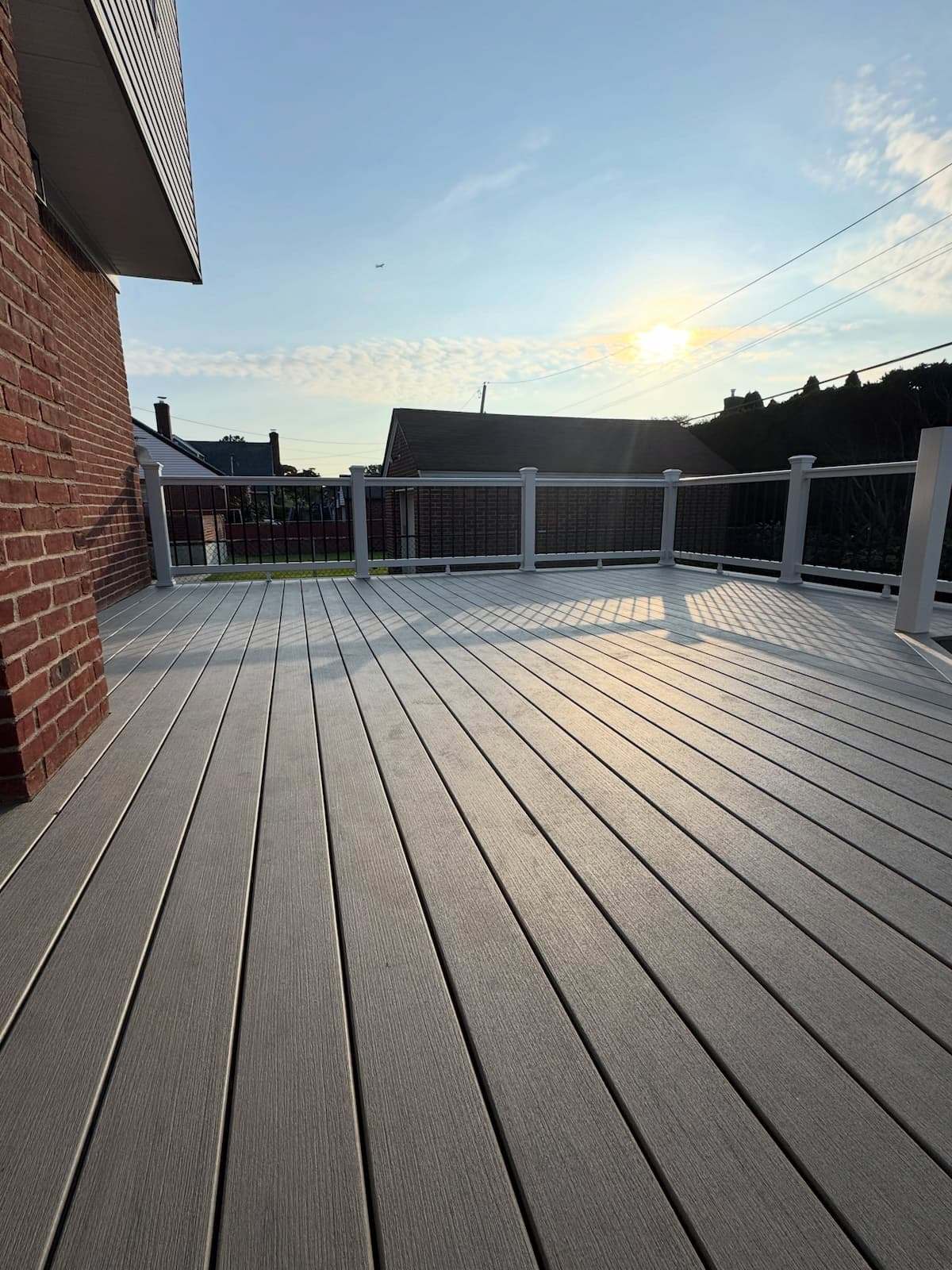 Trex composite deck boards and railing along the back of a brick Doylestown, PA home